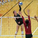 Alayna Santel hits over a pair of blockers
