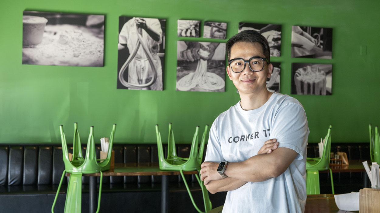 UMSL alum Xin Wei, owner of Corner 17, stands in the restaurant's dining room