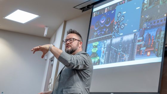 Nick Bowman gestures during lecture