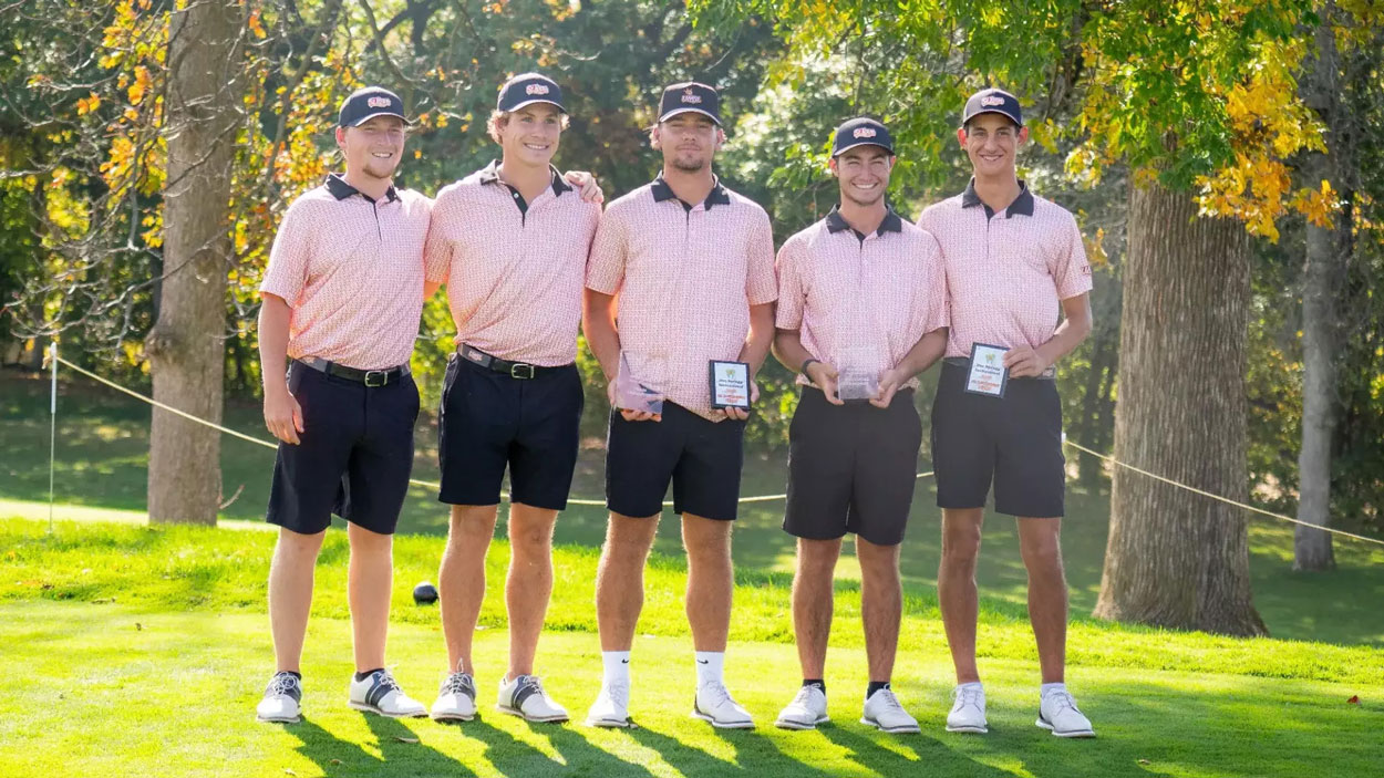 Members of the UMSL men's golf team holding plaques after winning the Doc Spragg Invitational