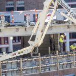 Construction crew members work on the exterior wall of the Engineering Design and Innovation Studio on the first floor of Stadler Hall at the University of Missouri–St. Louis