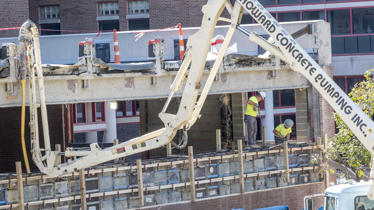Construction crew members work on the exterior wall of the Engineering Design and Innovation Studio on the first floor of Stadler Hall at the University of Missouri–St. Louis