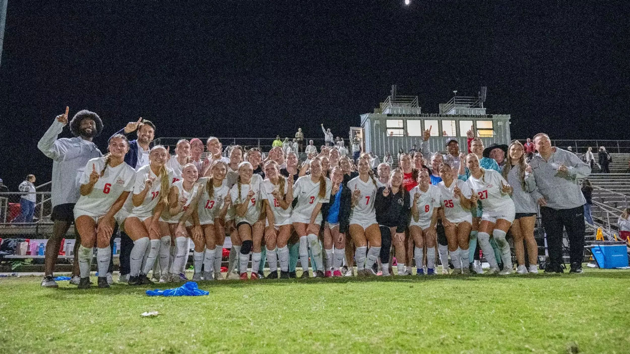 UMSL's women's soccer team celebrating the GLVC regular-season title