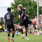 UMSL men's soccer player Brady Freeman celebrates with teammates after scoring a goal