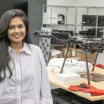 Supria Sarkar stands near a drone in the Geospatial Advanced Technology Lab