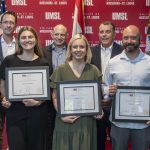 Lindbergh educators Megan Vallis, Noelle Nations and Robert Zielinski hold certificates while surrounded by Congressman Wesley Bell, Lindbergh Director of AI and Blended Learning Colin Davitt, Scale AI Head of Workforces and Workspaces AJ Segal, Lindbergh Schools Superintendent Tony Lake and UMSL Interim Chancellor Chris Spilling