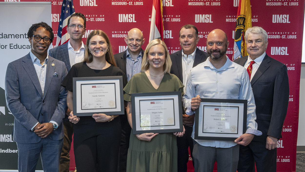 Lindbergh educators Megan Vallis, Noelle Nations and Robert Zielinski hold certificates while surrounded by Congressman Wesley Bell, Lindbergh Director of AI and Blended Learning Colin Davitt, Scale AI Head of Workforces and Workspaces AJ Segal, Lindbergh Schools Superintendent Tony Lake and UMSL Interim Chancellor Chris Spilling