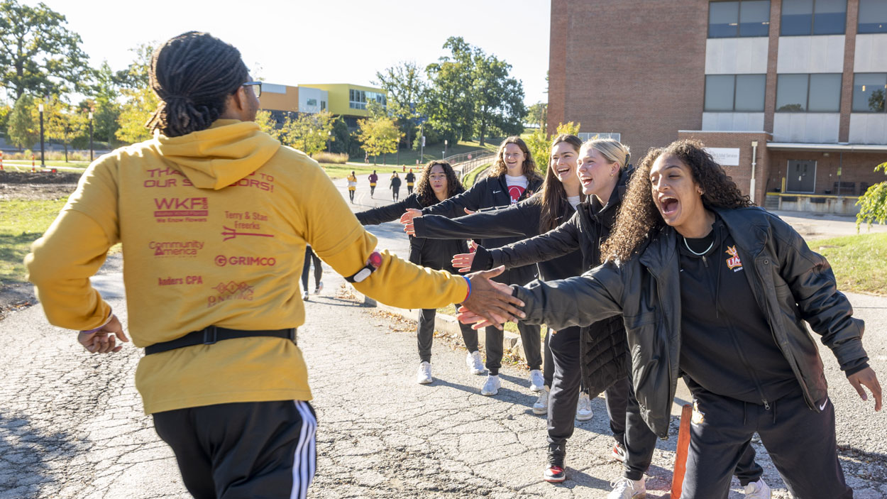 Tyler Haynes receives high-fives during the UMSL 5K Run/Walk